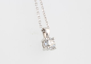 An 18ct white gold brilliant cut diamond pendant and chain, approx. 0.51ct, the chain is 44cm and weighs 3.3 grams together with a WGI certificate 