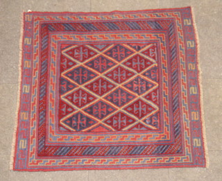 A red and blue ground Meshwani Gazak rug with diamond design to the centre within a multi row border 123cm x 118cm 