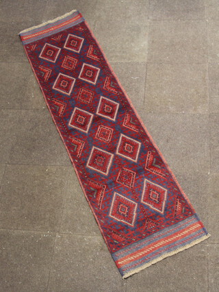 A red and blue ground Meshwani runner with 15 diamonds to the centre 240cm x 61cm 