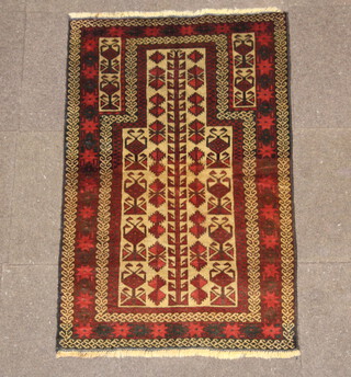 A red and tan ground Baluchi prayer rug 128cm x 83cm 