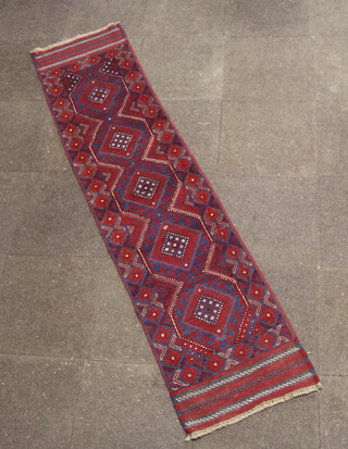 A blue and red ground Meshwani runner with 5 diamonds to the centre 247cm x 58cm 