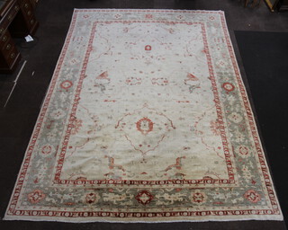 A white, red and green ground Caucasian style carpet 444cm x 291cm 