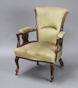 An Edwardian Art Nouveau mahogany open armchair, the seat and back upholstered in green material raised on cabriole supports 90cm h x 65cm w (inside seat measurement 53cm w x 67cm d) 