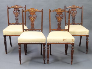 A set of 4 Victorian inlaid rosewood slat back dining chairs with pierced heart shaped slat backs and over stuffed seats, raised on turned supports 