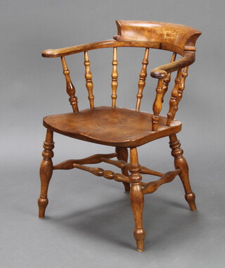 A 19th Century elm smokers bow chair with bobbin turned decoration and double H framed stretcher, the seat marked J C 76cm h x 62cm w x 46cm d (inside seat 38cm w x 37cm d)