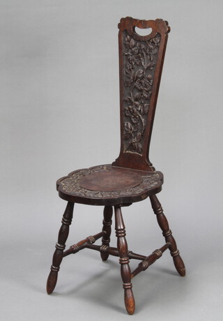 A Victorian carved oak spinning chair, raised on turned supports with H framed stretcher 91cm h x 36cm w x 37cm d 