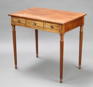 A Georgian style rectangular mahogany writing table fitted 3 drawers raised on turned and reeded supports 78cm h x 85cm w x 58cm d 