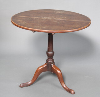 A 19th Century circular mahogany snap top wine table raised on gun barrel turned column and tripod base 71cm h x 77cm diam. 