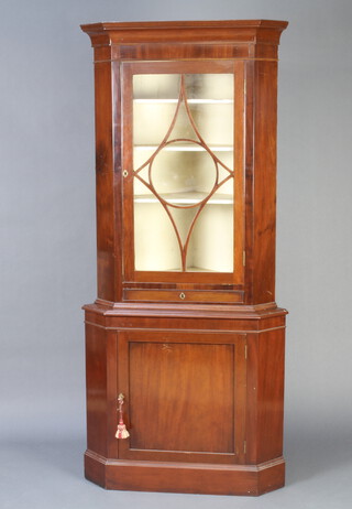 A 19th Century mahogany double corner cabinet, the upper section with moulded cornice fitted a cupboard enclosed by astragal glazed panelled door with drawer, the base enclosed by a panelled door 192cm h x 87cm w x 59cm d 