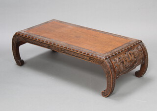 A 1920's Chinese rectangular carved hardwood opium table raised on scroll supports 33cm h x 100cm w x 49cm d 