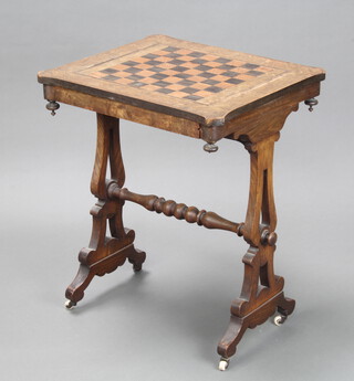 A Victorian shaped inlaid mahogany games table, the top inlaid a chessboard with floral and lion mask inlay, fitted a frieze drawer and raised on pierced panelled supports with turned H framed stretcher 68cm h x 54cm w x 46cm d 