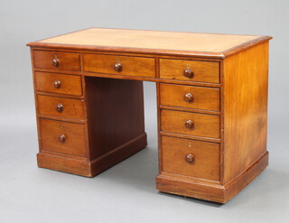 A Victorian mahogany kneehole pedestal desk with brown tooled leather writing surface fitted 1 long and 8 short drawers with tore handles and brass escutcheons 75cm h x 121cm w x 64cm d 