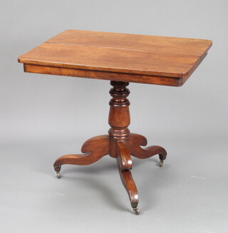 A Victorian rectangular mahogany tea table raised on turned column and tripod base ending in brass caps and castors 70cm h x 81cm w x 65cm d 