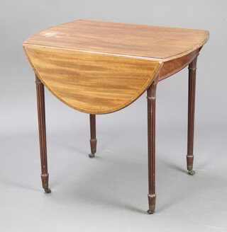 An Edwardian Sheraton style oval inlaid and crossbanded mahogany Pembroke table, raised on turned and fluted supports ending in brass caps castors 71cm h x 76cm w x 53cm when closed by 105cm when open  