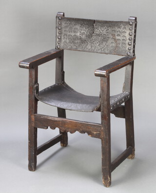 A 17th Century style oak and leather open arm chair with embossed leather back and seat, raised on square supports 100cm h x 58cm w x 49cm d (inside seat measurement 38cm x 49cm)