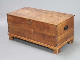A Georgian oak coffer with hinged lid, raised on replacement bracket feet with iron drop handles 44cm h x 98cm w x 50cm d 