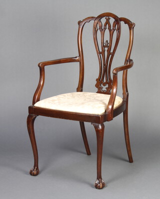 An Edwardian Chippendale style mahogany dining chair with pierced vase shaped slat back and upholstered drop in seat, raised on cabriole ball and claw supports 