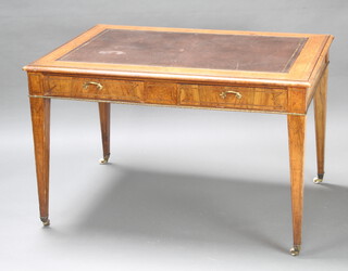 A Victorian inlaid amboyna library table with brown inset writing surface with satinwood stringing, fitted 2 drawers, raised on square tapered supports, brass caps and ceramic castors 77cm h x 122cm w x 85cm d 