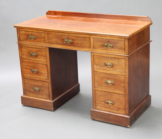 A Victorian walnut kneehole desk/dressing table with raised back, the base fitted 1 long and 8 short drawers, raised on a platform base  82 x 110cm w x 51cm d 