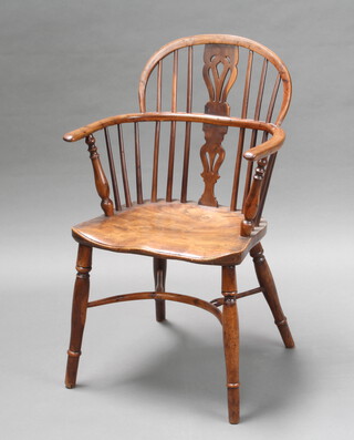 A 19th Century elm and yew comb back Windsor chair with solid elm seat, raised on turned supports with crinoline stretcher 88cm h x 55cm w x 39cm d, (inside seat 36cm w x 34cm d)