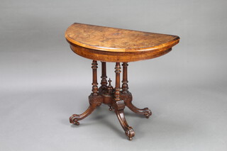 A Victorian oval inlaid figured walnut card table raised on 4 turned columns, 71cm h x 88cm w x 44cm d 