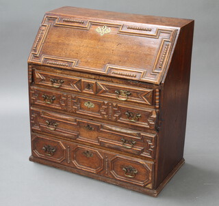An 18th Century oak bureau with geometric mouldings, the fall front revealing a fitted interior above 3 long drawers 90cm h x 84cm w x 43cm d 