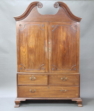 A Georgian mahogany linen press, the upper section with broken pediment, interior fitted 1 tray and hanging rail enclosed by a pair of panelled doors, the base fitted 2 short and 1 long drawer, raised on ogee bracket feet 206cm h x 129cm w x 47cm d 