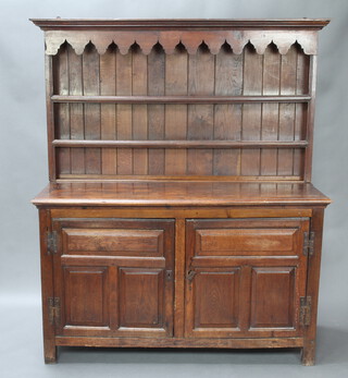 An 18th Century oak dresser, the raised back with moulded cornice fitted 2 shelves, the base fitted a double cupboard enclosed by panelled doors and with iron H framed hinges 180cm h x 150cm w x 54cm d  