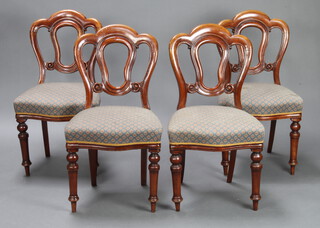 A set of 4 Victorian mahogany Admiralty tulip back dining chairs with overstuffed seats, raised on turned supports 