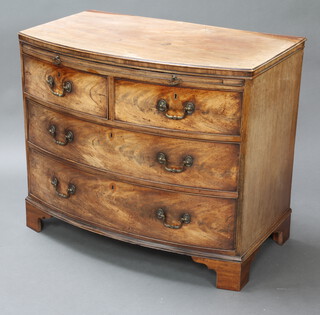 A Georgian mahogany bow front chest with brushing slide above 2 short and 2 long drawers with brass handles and escutcheons, raised on replacement bracket feet 84cm h x 99cm w x 59cm d 