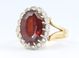 An 18ct yellow gold garnet and diamond cluster ring size R, 7.8 grams