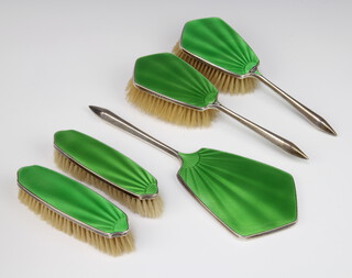 An Art Deco silver and green guilloche enamel dressing table set comprising 2 hair brushes, 2 clothes brushes, hand mirror and comb, Birmingham 1930