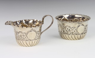 A Victorian repousse silver cream jug and sugar bowl Birmingham 1893, 92 grams 