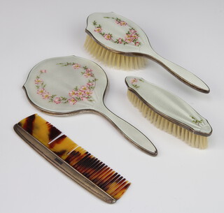 A silver and guilloche enamel dressing table set comprising hand mirror, hair brush, clothes brush and comb decorated with flowers, Birmingham 1961