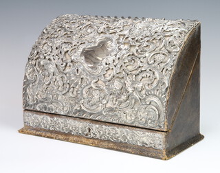 An Edwardian repousse silver dome top stationery box with scrolls and flowers having a vacant cartouche, maker William Comyns, 31cm 