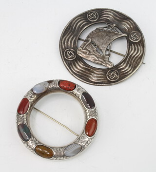 A Scottish silver brooch decorated with a Knorr Glasgow 1902 together with a Scottish silver hardstone inlaid circular brooch, gross 70 grams 