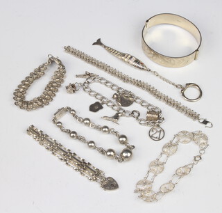 A silver bangle and minor silver jewellery, 131 grams