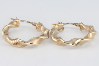 A pair of 9ct yellow gold twist hoop earrings 1.4 grams