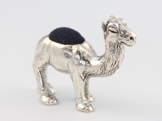 A novelty sterling silver pin cushion in the form of a camel 16 grams gross, 3cm