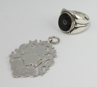 A silver sports medal together with a gentleman's silver and enamel signet ring 18 grams gross 