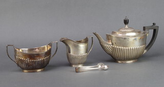 A silver 3 piece demi-fluted tea set with ebony mounts, Sheffield 1907 and London 1906 and 1907, gross weight 984 grams 