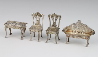 A Continental repousse silver model of a bench, ditto side table and 2 chairs, 50 grams  
