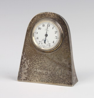 A silver desk top timepiece with enamelled dial, seconds at 6 o'clock, Dublin 1946, engraved monogram 9cm 