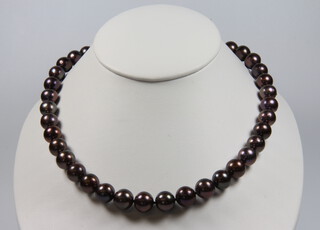 A string of purple cultured pearls with a 9ct clasp 44cm 