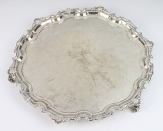 A circular silver salver with Chippendale rim on scroll feet, Birmingham 1954, 39cm diam. 1220 grams