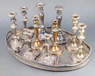An oval silver plated 2 handled galleried tray 64cm together with 5 pairs of plated candlesticks 
