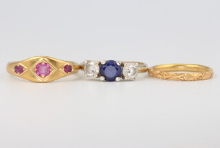 A 22ct yellow gold wedding band, size N, 2.2 grams, a 22ct gold Victorian ruby 3 stone ring size R 1/2 6.5 grams together with a 9ct yellow gold sapphire and gem set ring size R 3.2 grams 