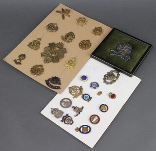 A collection of World War Two and other cap badges, enamelled pins and badges 