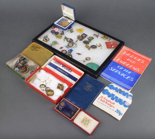 A collection enamelled and other pin badges including a silver sports medallion