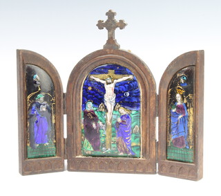 A 19th Century Continental enamel on copper triptych contained in an oak frame depicting Christ on the Cross with attendants 19cm 